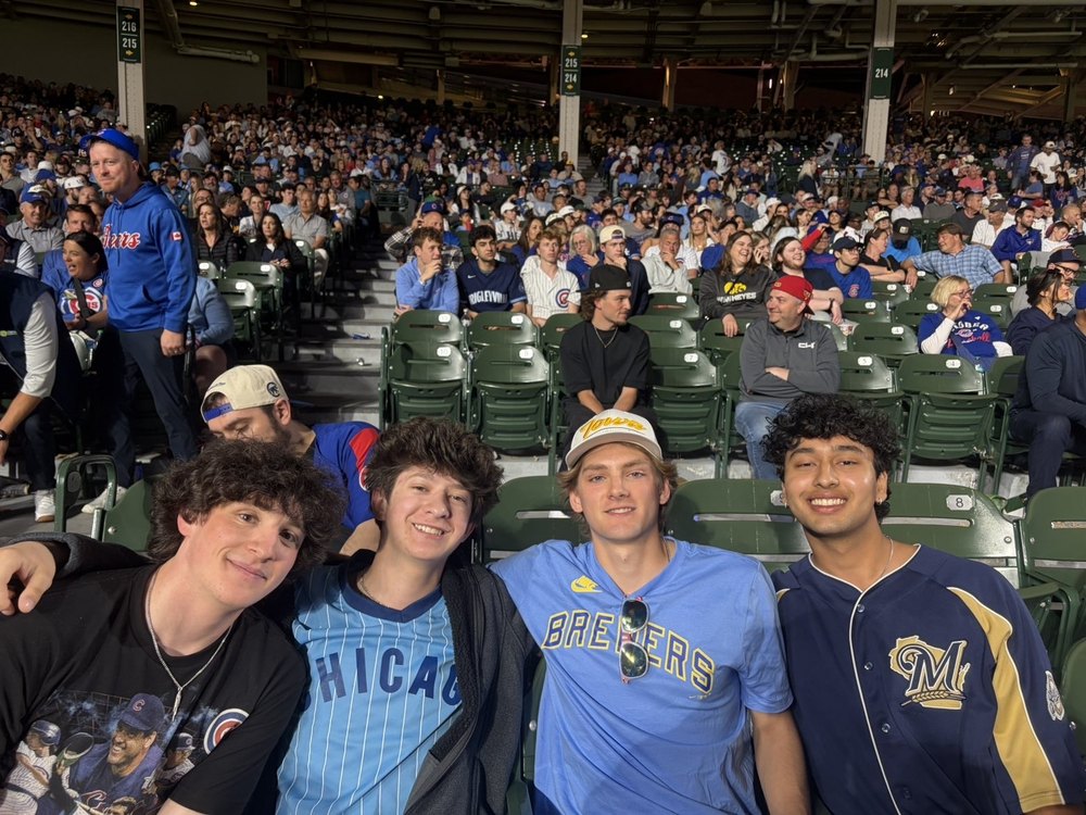 Shash with friends in the stands at a baseball game