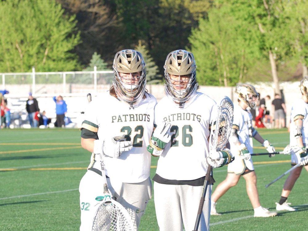 Shash on the field with a teammate during a lacrosse game